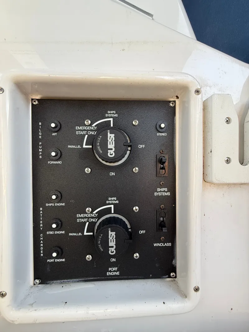 Slide: The Image of Control panel of a 2004 Four 328 Vista boat with switches and dials. - 22