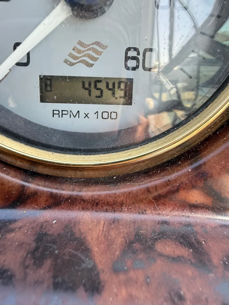 Slide: The Image of Close-up of a Four 328 Vista 2004 tachometer showing 4549 RPM x 100. - 23