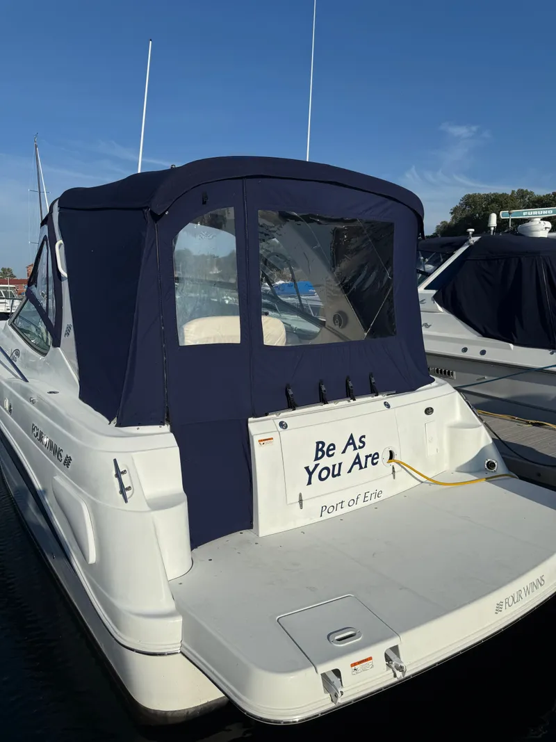 Slide: The Image of 2004 Four 328 Vista boat docked, featuring "Be As You Are" text, Port of Erie. - 25