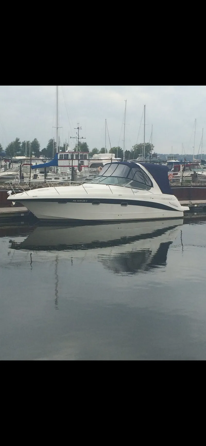 Slide: The Image of 2004 Four 328 Vista boat docked in a marina, reflecting on calm water. - 27