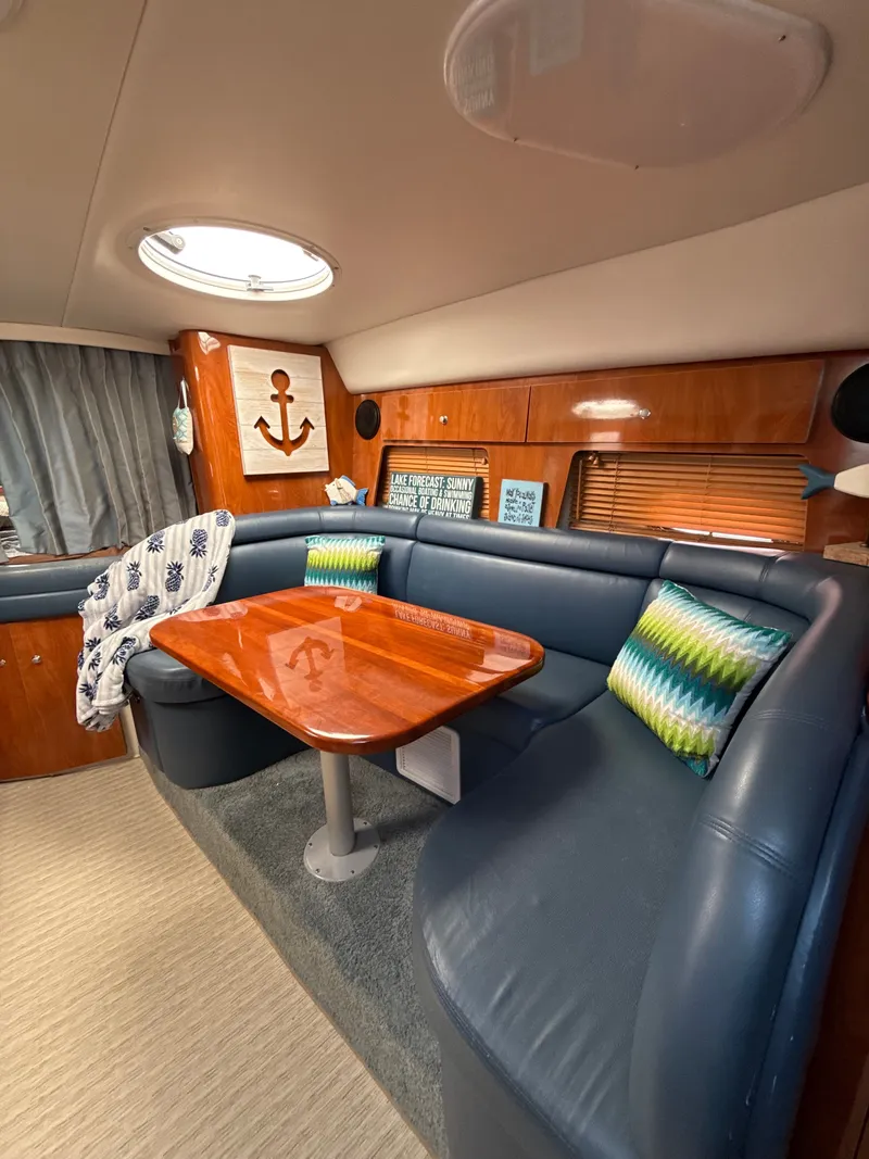 Slide: The Image of Luxurious 2004 Four 328 Vista yacht interior with plush seating and wooden table. - 4