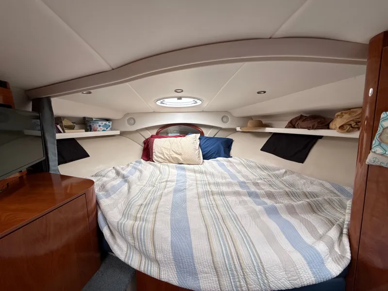 Slide: The Image of Cozy cabin interior of 2004 Four 328 Vista boat with bed and storage shelves. - 7