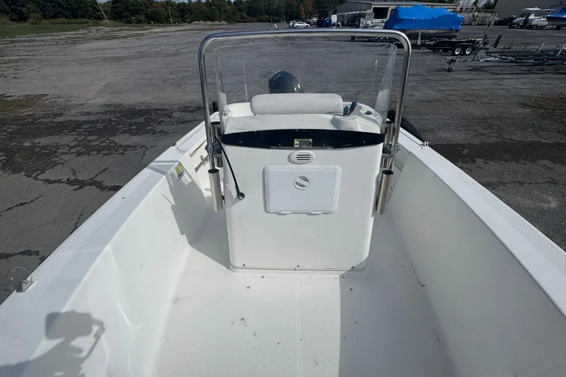 Slide: The Image of 2007 Trophy 1703 Center Console boat on dry land, showcasing helm and seating area. - 12