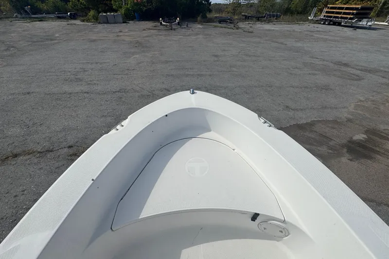 Slide: The Image of 2007 Trophy 1703 Center Console boat on a paved surface, surrounded by greenery. - 13