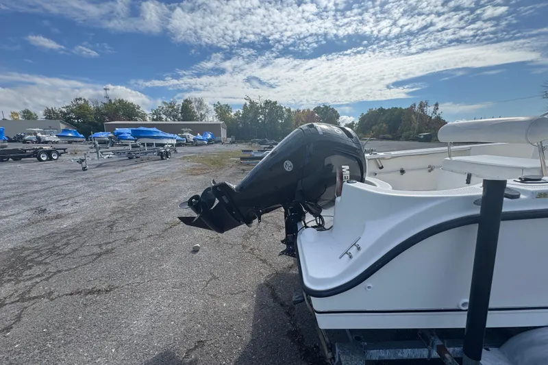 Slide: The Image of 2007 Trophy 1703 Center Console boat with outboard motor in a parking lot. - 14