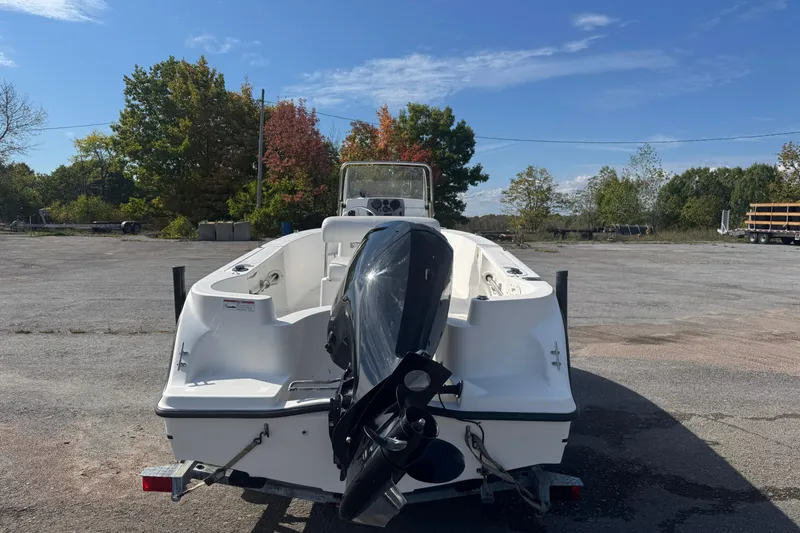 Slide: The Image of 2007 Trophy 1703 Center Console boat with outboard motor in a parking lot. - 3