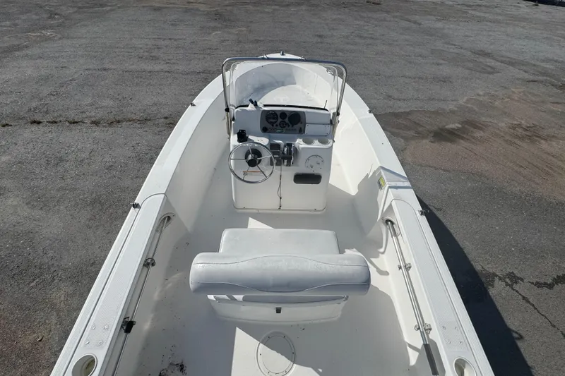 Slide: The Image of 2007 Trophy 1703 Center Console boat with steering wheel and seating, parked on pavement. - 6