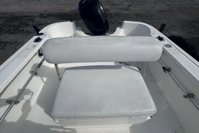 Slide: The Image of 2007 Trophy 1703 Center Console boat interior with white seating and motor. - 8