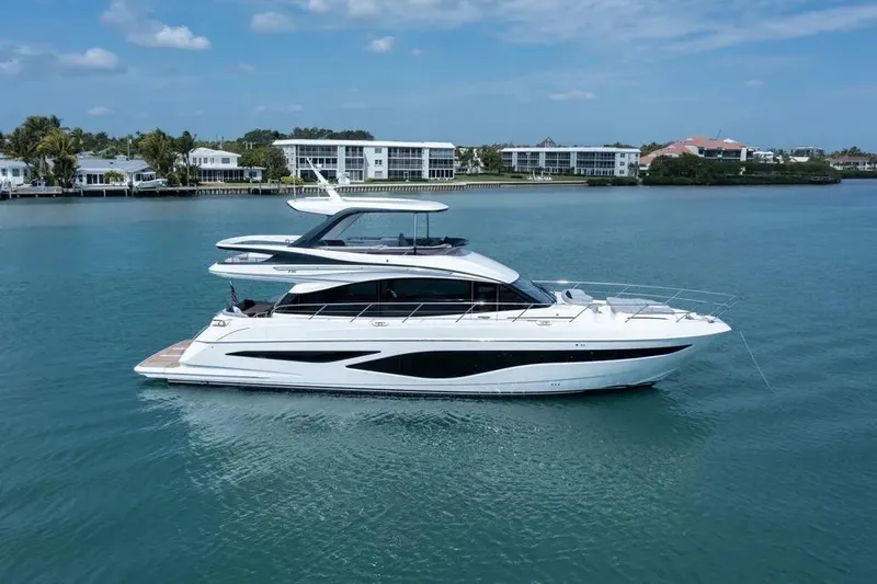 Slide: The Image of Luxurious 2026 Princess F65 yacht cruising on serene blue waters near coastal homes. - 0