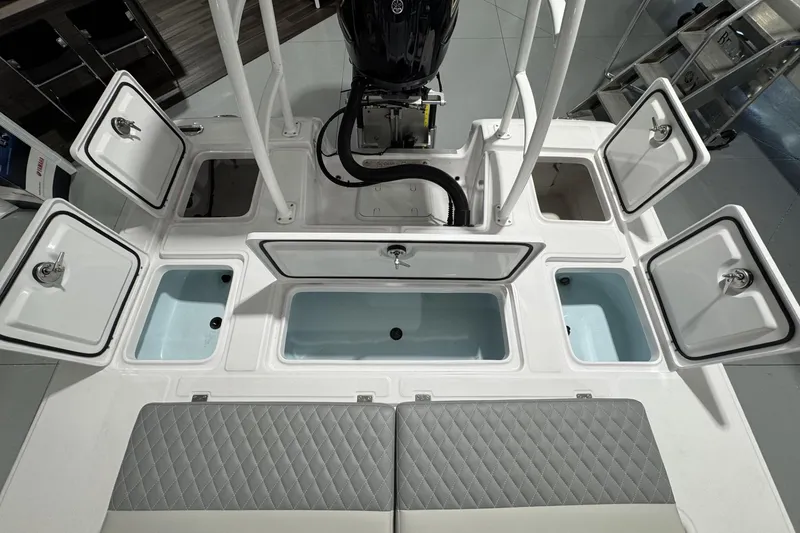 Slide: The Image of 2026 Action Craft 20 Flatsmaster boat dashboard with steering wheel and navigation screen. - 15