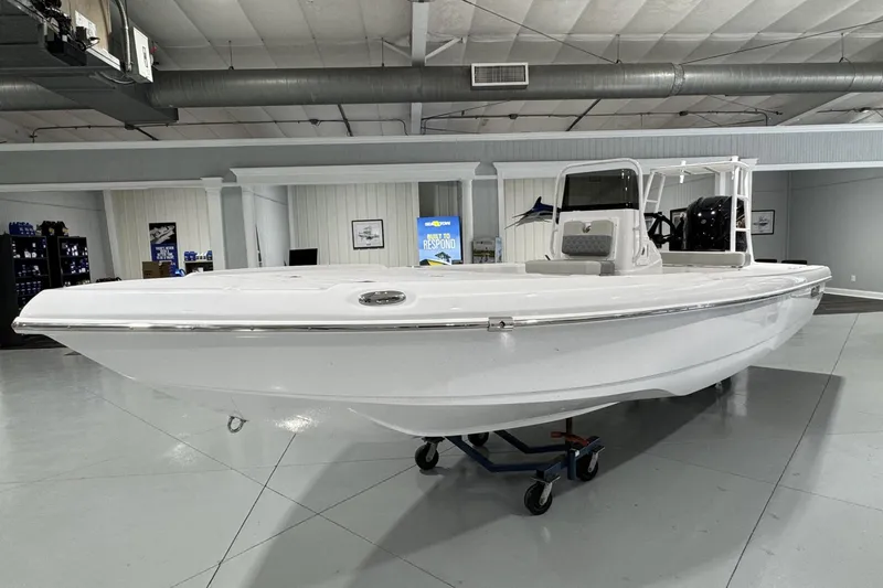 The Image of 2026 Action Craft 20 FLATSMASTER boat cruising on a scenic waterway. - 0