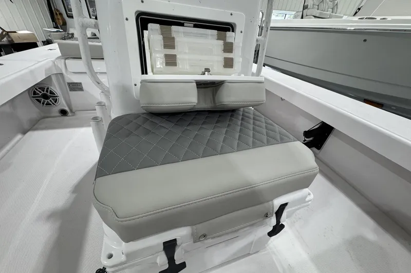 Slide: The Image of 2026 Action Craft 20 Flatsmaster boat with open storage compartments in a showroom. - 11