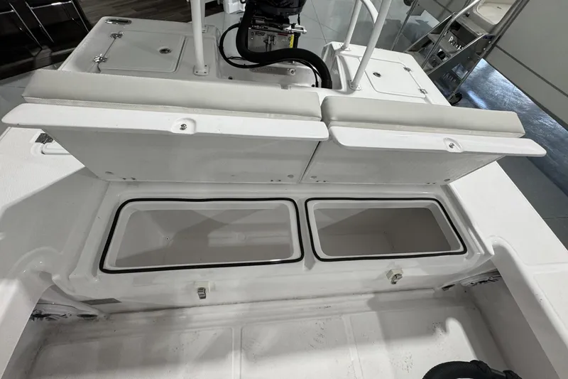 Slide: The Image of 2026 Action Craft 20 Flatsmaster boat interior with rod holders and blue LED light. - 16