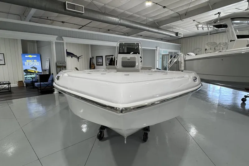 Slide: The Image of Overhead view of 2026 Action Craft 20 FLATSMASTER boat on green water. - 2