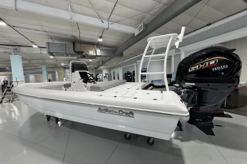 Slide: The Image of 2026 Action Craft 20 Flatsmaster boat displayed indoors on a trailer. - 4