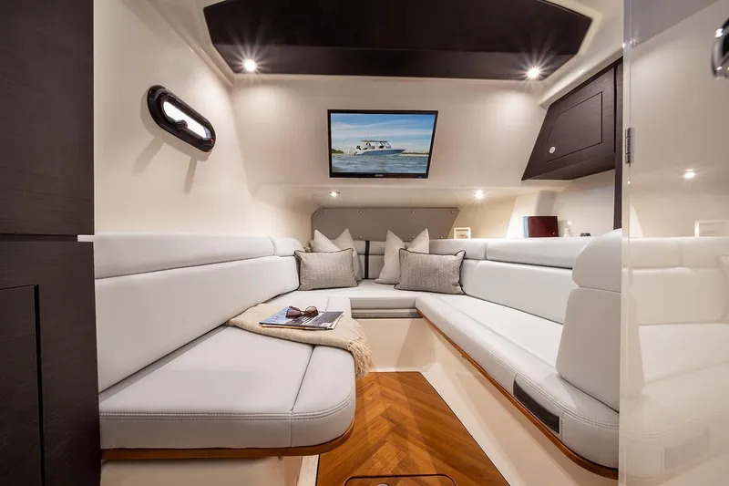 Slide: The Image of Manufacturer Provided Image: Luxurious interior of 2026 Boston Whaler 350 Realm boat with plush seating and modern decor. - 11