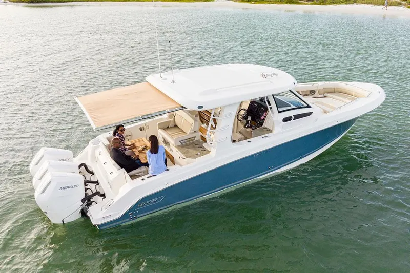 Slide: The Image of Manufacturer Provided Image: 2026 Boston Whaler 350 Realm boat on water, featuring spacious deck and modern design. - 3