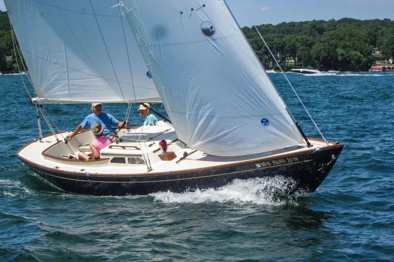 The Image of Sailing on a 2012 Morris Yachts M29, three people enjoy a sunny day on the water. - 1
