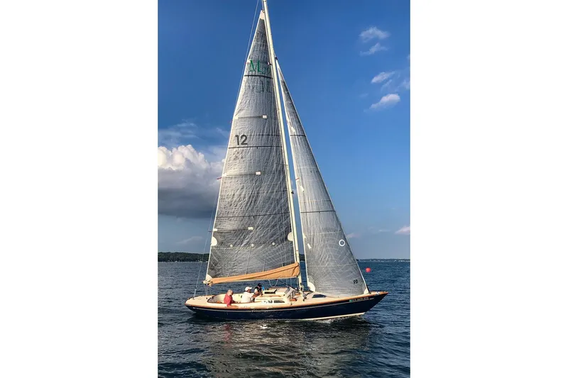 Slide: The Image of Sailing yacht Morris Yachts M29, 2012 model, gliding on calm waters under a clear blue sky. - 17