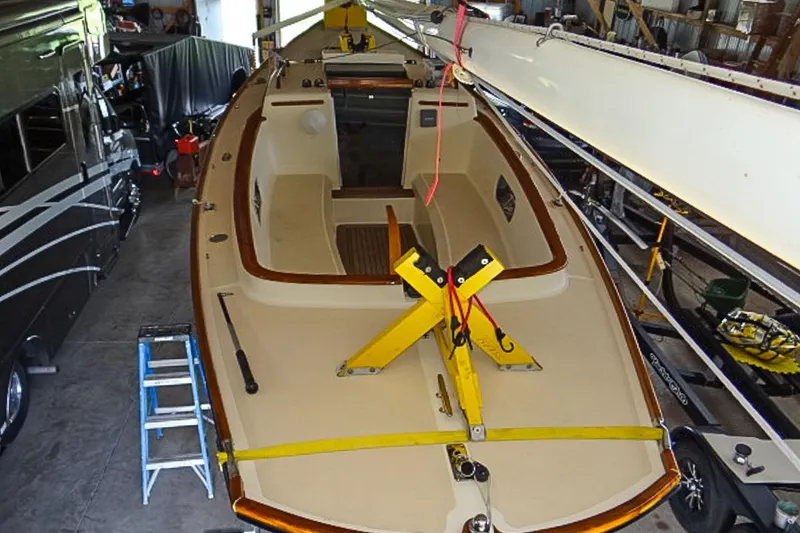 Slide: The Image of 2012 Morris Yachts M29 sailboat in storage, with mast secured and interior visible. - 6