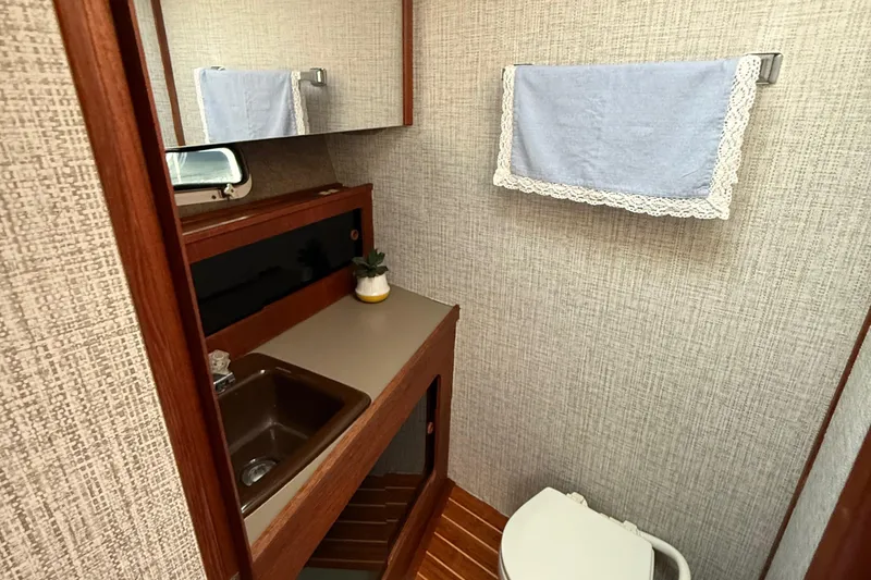 Slide: The Image of 1983 Bayliner 3870 Motoryacht bathroom with sink, mirror, and towel rack. - 10