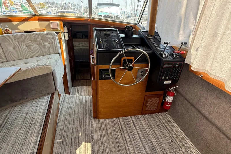 Slide: The Image of 1983 Bayliner 3870 Motoryacht interior helm with steering wheel and control panel. - 15