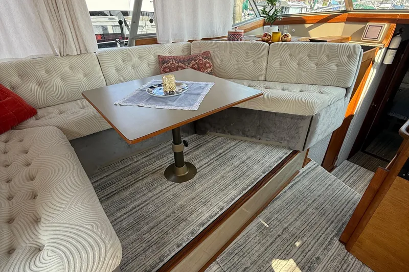 Slide: The Image of Interior of 1983 Bayliner 3870 Motoryacht with cozy seating and elegant decor. - 16