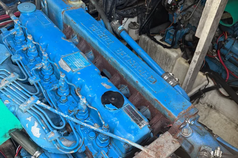 Slide: The Image of Engine of 1983 Bayliner 3870 Motoryacht, featuring blue components and visible wiring. - 4