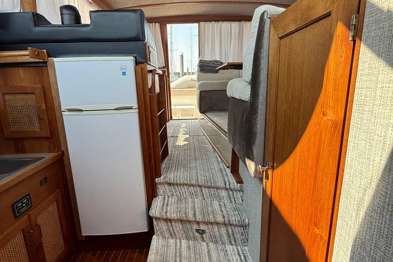 Slide: The Image of Interior of 1983 Bayliner 3870 Motoryacht with wooden cabinetry and compact kitchen area. - 8