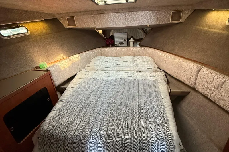 Slide: The Image of Cozy cabin interior of 1983 Bayliner 3870 Motoryacht with bed and soft lighting. - 9