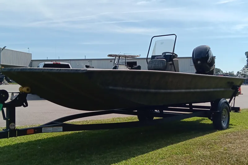 Slide: The Image of 2026 Tracker Grizzly 1860 CC boat on trailer, parked outdoors. - 5