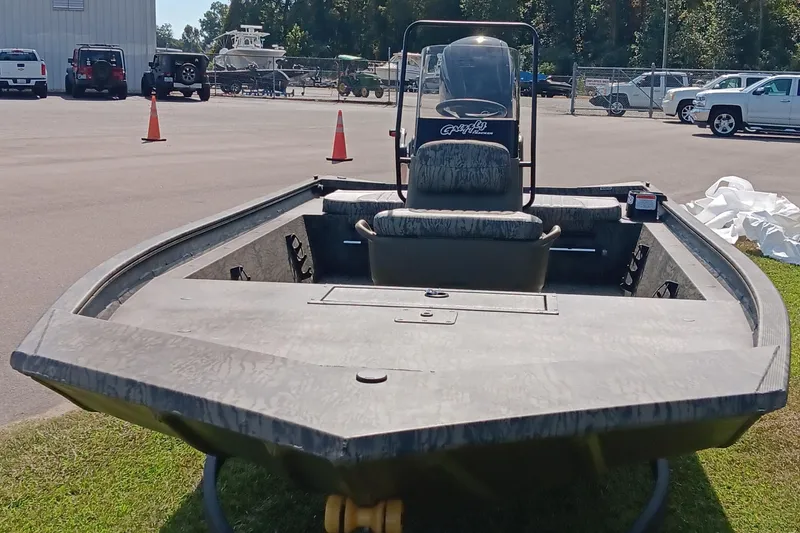 Slide: The Image of 2026 Tracker Grizzly 1860 CC boat displayed outdoors on grass. - 6