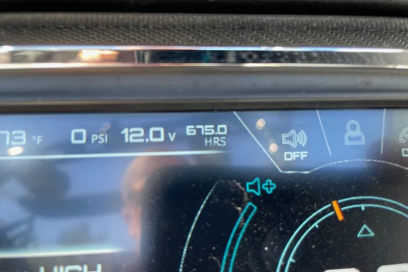 Slide: The Image of Dashboard display of a 2016 Nautique Super Air Nautique G21 showing 12.0 volts and 675 hours. - 13