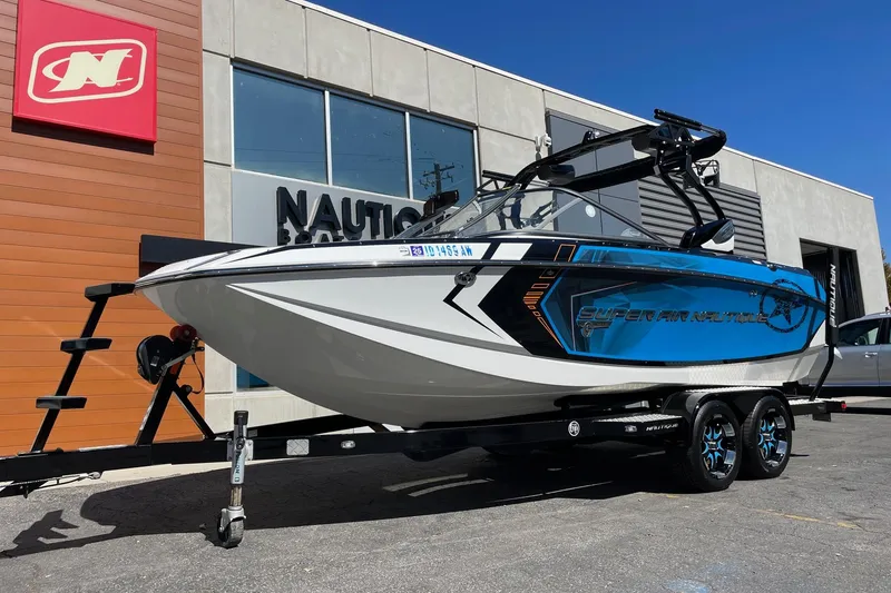 Slide: The Image of 2016 Nautique Super Air Nautique G21 boat on trailer outside dealership. - 2