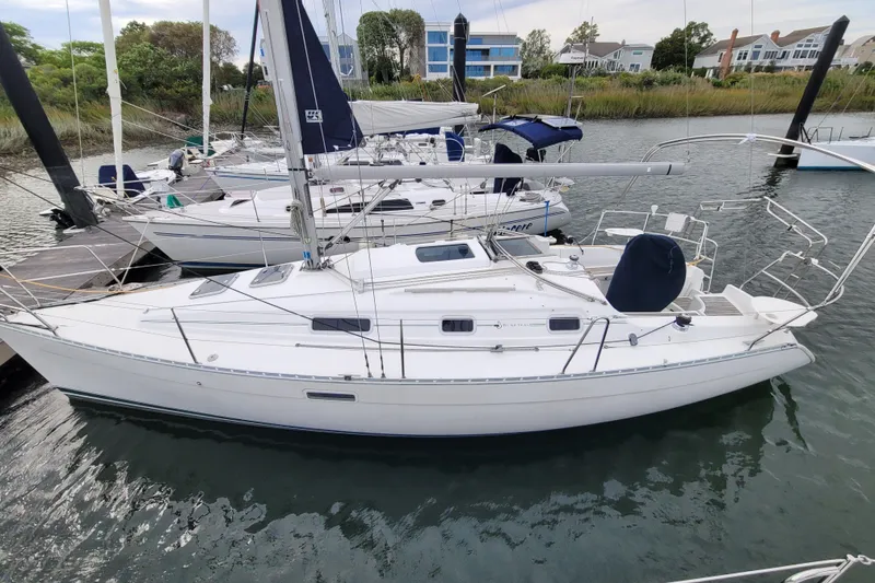 Slide: The Image of 2002 Beneteau Oceanis 311 sailboat docked in a marina, side view. - 1