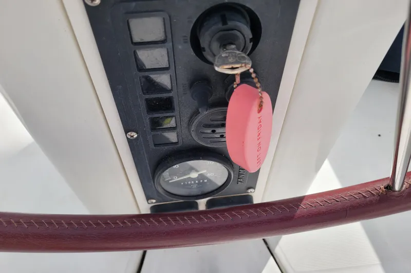 Slide: The Image of Control panel of a 2002 Beneteau Oceanis 311 sailboat with key and gauge. - 12