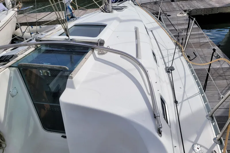 Slide: The Image of 2002 Beneteau Oceanis 311 sailboat docked, showcasing deck and cabin details. - 14