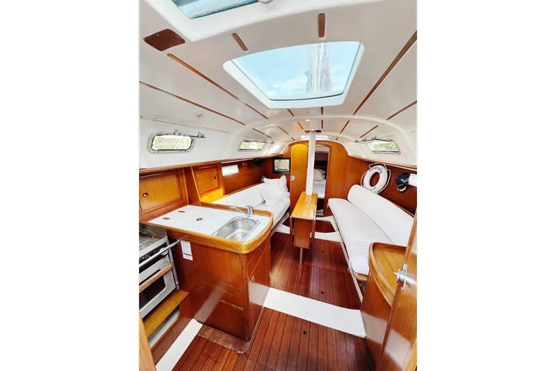 Slide: The Image of Interior of 2002 Beneteau Oceanis 311 sailboat with wood finish and skylight. - 17