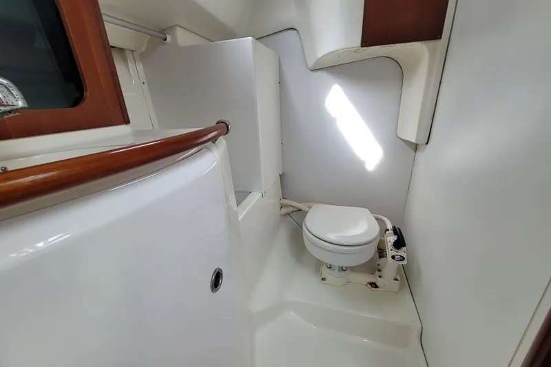 Slide: The Image of Beneteau Oceanis 311 2002 yacht bathroom with toilet and wooden accents. - 24