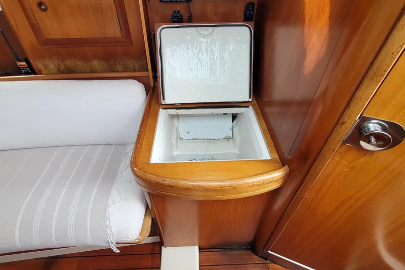 Slide: The Image of Interior of 2002 Beneteau Oceanis 311 sailboat with open storage compartment. - 27