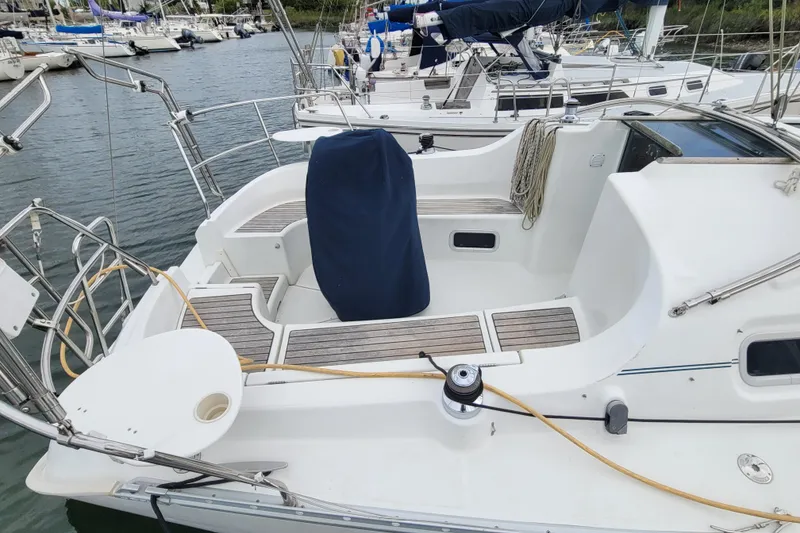 Slide: The Image of 2002 Beneteau Oceanis 311 sailboat cockpit with covered wheel, docked in marina. - 3