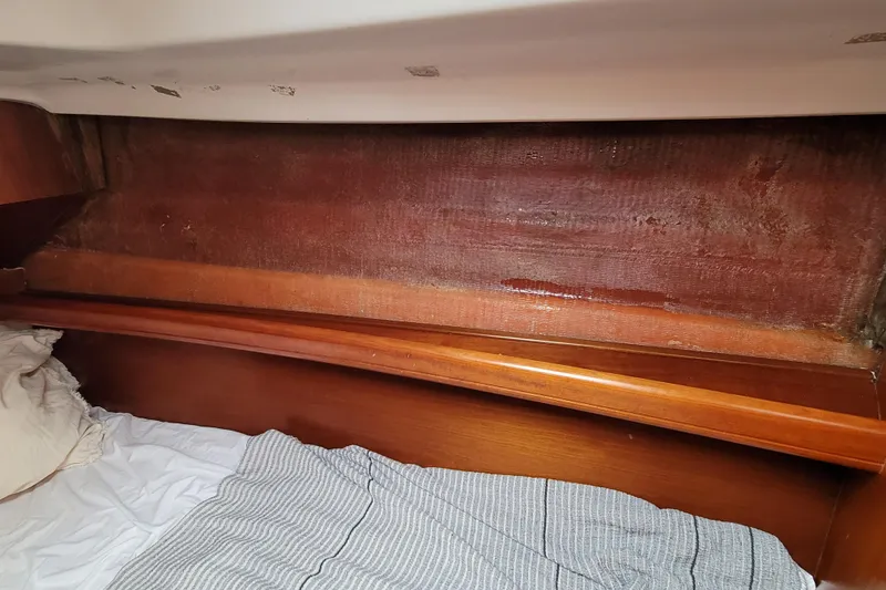 Slide: The Image of Interior cabin of 2002 Beneteau Oceanis 311 sailboat with wooden trim and bedding. - 35