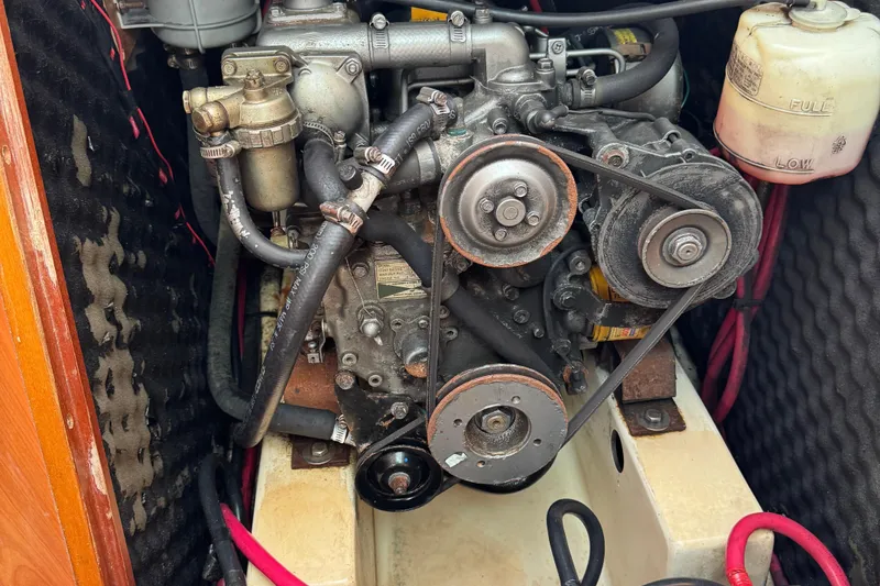 Slide: The Image of Engine compartment of a 2002 Beneteau Oceanis 311 sailboat, showing detailed mechanical components. - 36