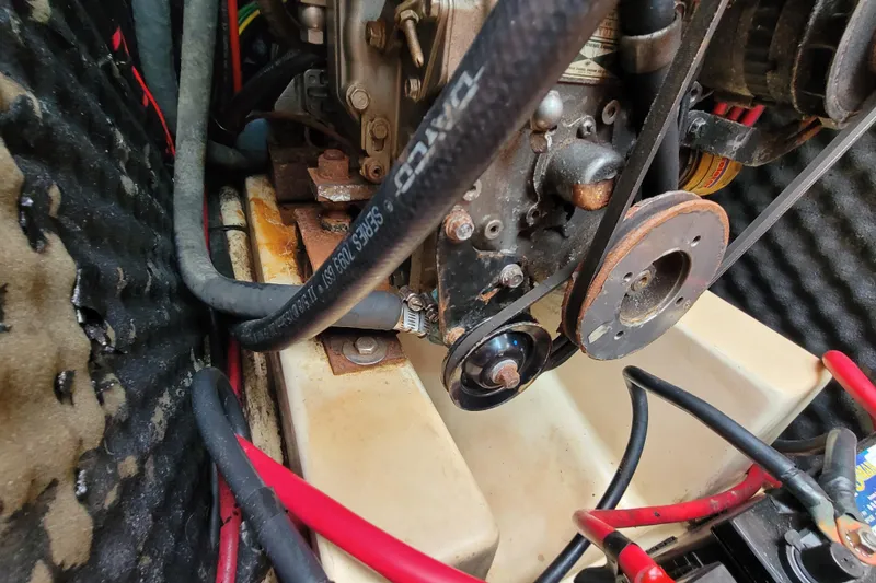 Slide: The Image of Engine compartment of a 2002 Beneteau Oceanis 311 sailboat, showing hoses and components. - 39