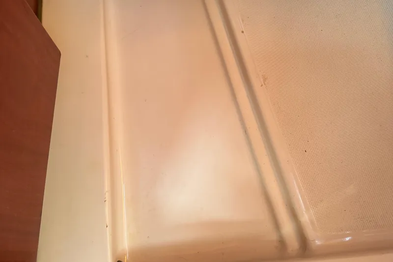 Slide: The Image of Interior detail of a 2002 Beneteau Oceanis 311 sailboat, showing a clean, textured surface. - 41