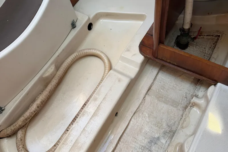 Slide: The Image of Interior view of a 2002 Beneteau Oceanis 311 sailboat, showing plumbing and flooring details. - 43