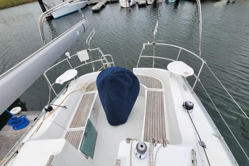 Slide: The Image of 2002 Beneteau Oceanis 311 sailboat cockpit with covered wheel, docked in marina. - 6