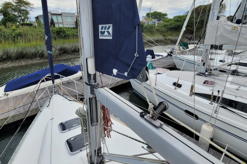 Slide: The Image of Beneteau Oceanis 311 sailboat docked, showcasing mast and rigging, 2002 model. - 7