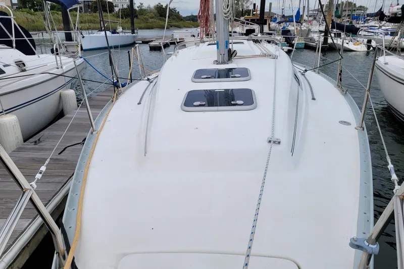 Slide: The Image of 2002 Beneteau Oceanis 311 sailboat docked at marina, view of deck and hatches. - 8