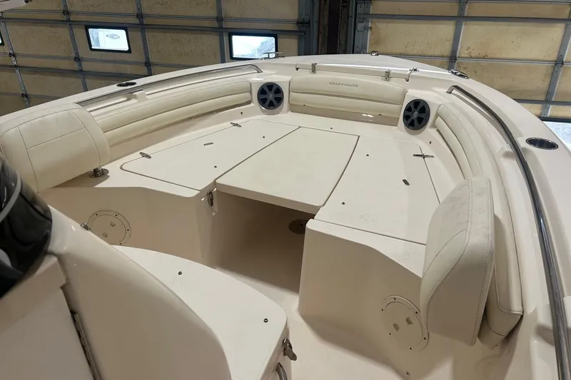 Slide: The Image of 2021 Grady-White Fisherman 216 boat interior with cushioned seating and storage compartments. - 2